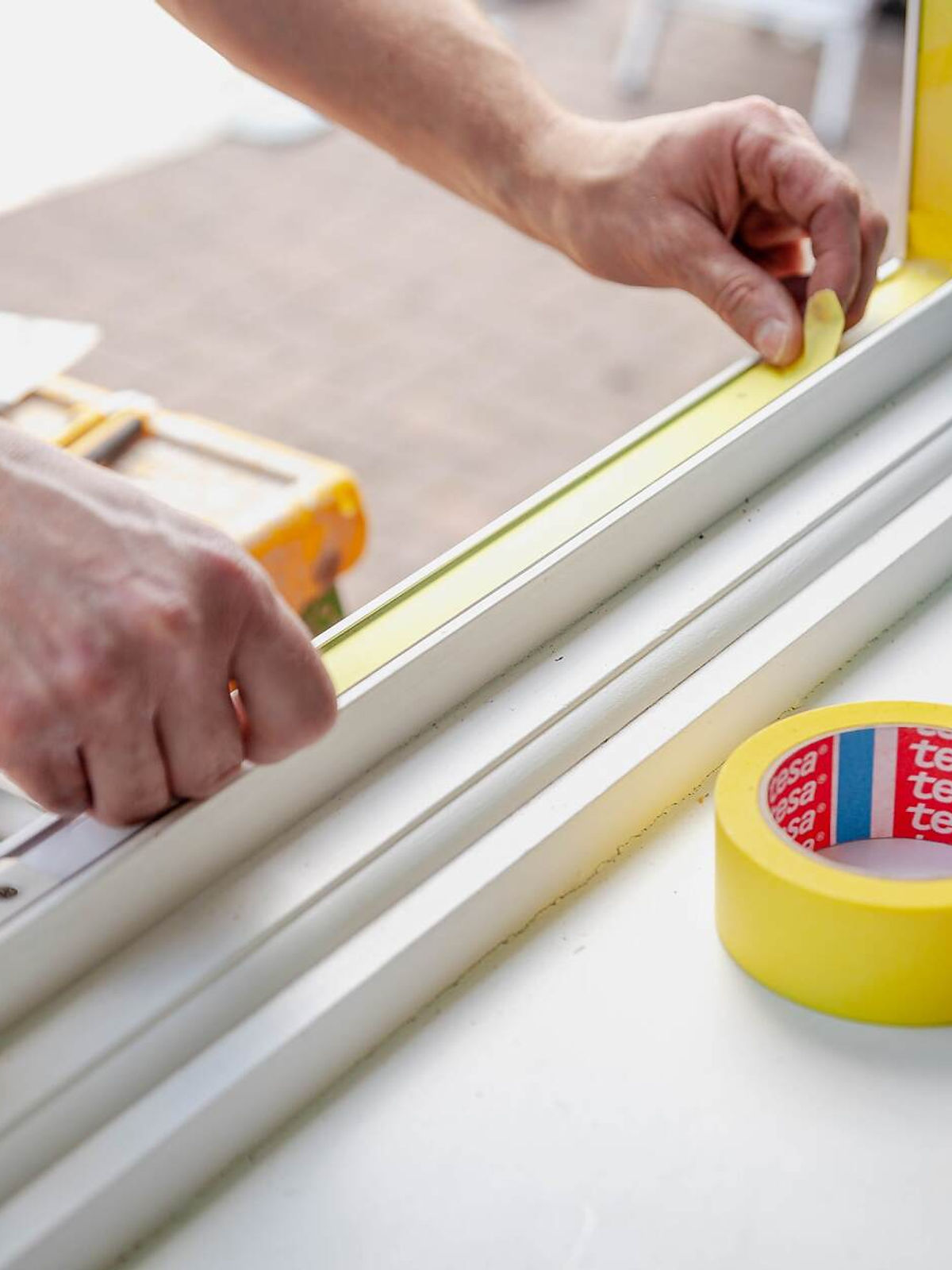 Technician spraying a window frame on site